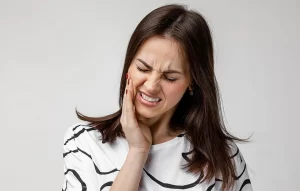 Female patient with sharp tooth pain in Cameron Park, CA